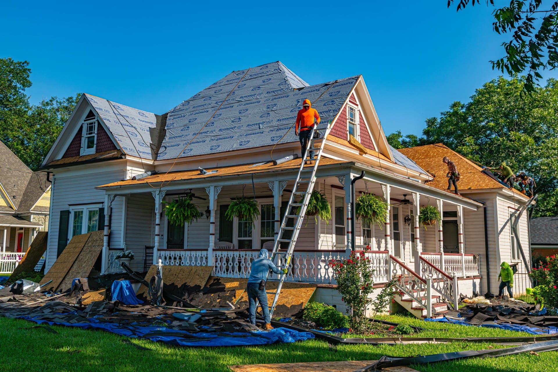 Roofers installing asphalt shingles on a Vermont home